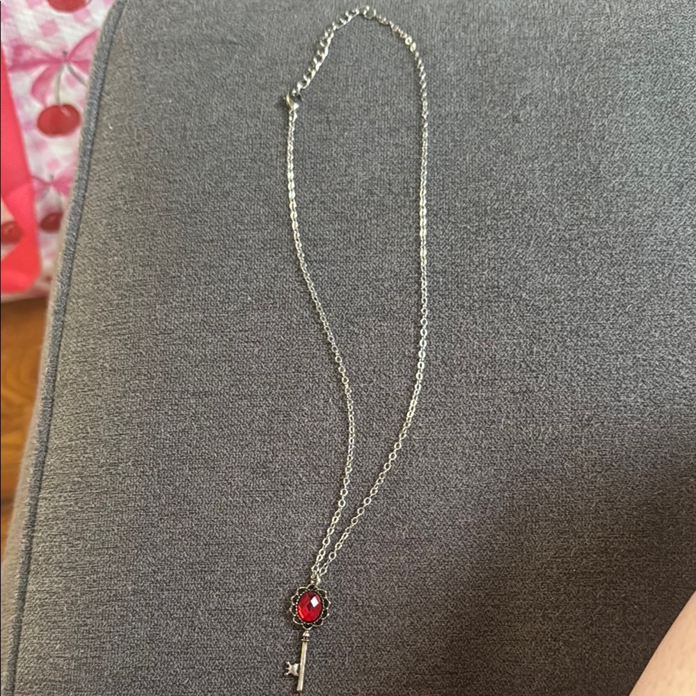Elegant Silver Key Pendant Necklace with Red Gemstone